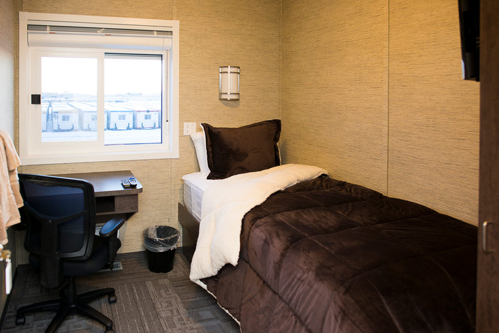 interior of relocatable structure showing bed and desk