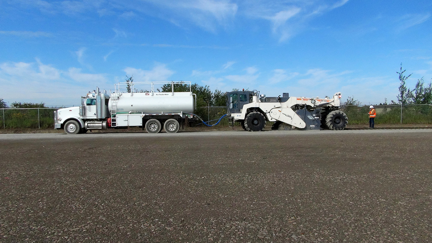 truck and heavy equipment on well maintained road