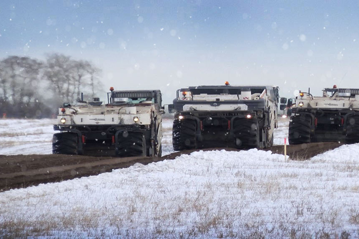 Heavy equipment removing frost on large field