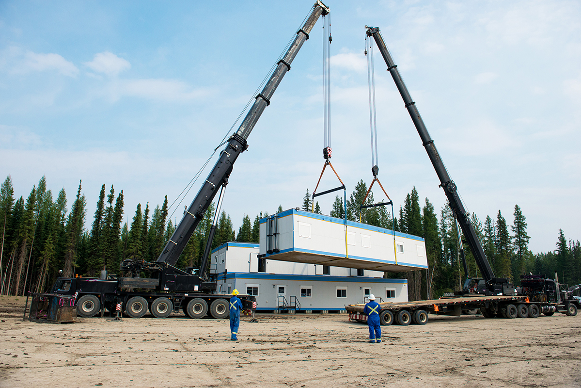 two cranes moving 2 mobile lodges