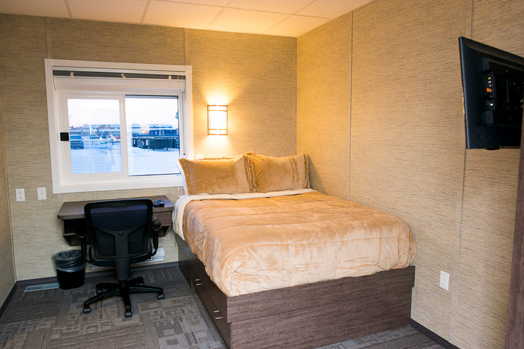 Two person relocatable structure showing double bed and desk