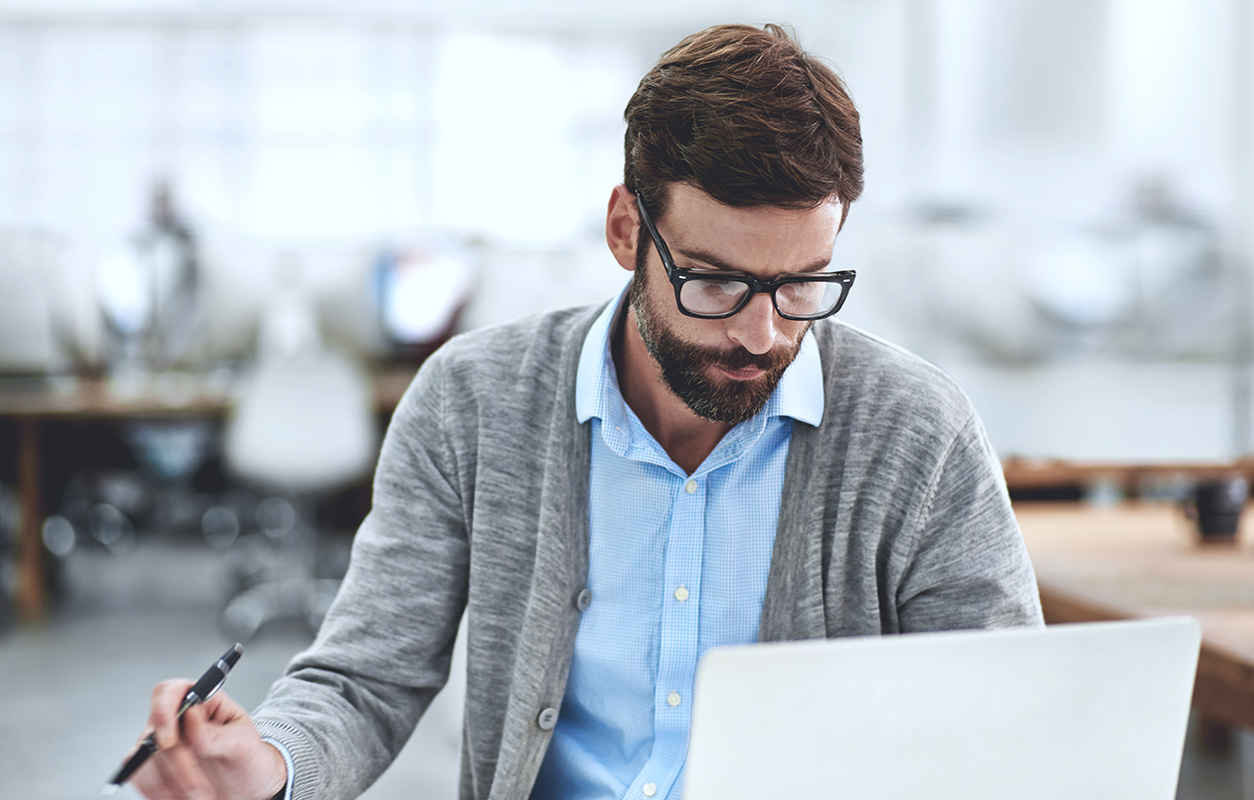 Man with glasses working at computer