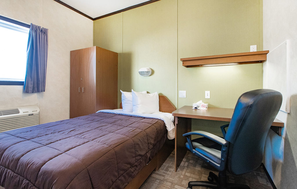 self contained relocatable structure showing single bed and living space