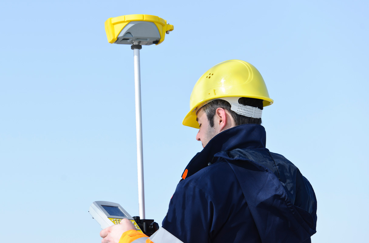 man wearing hard hat surveying